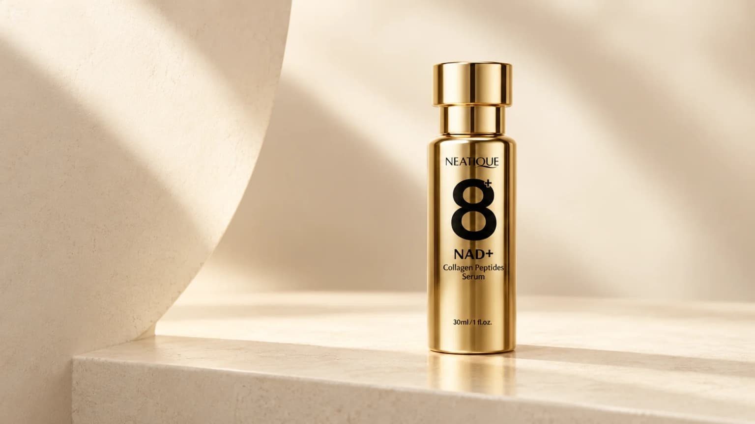 The unchanged gold NAD+ Serum bottle with sculptural ivory surfaces and soft champagne light.