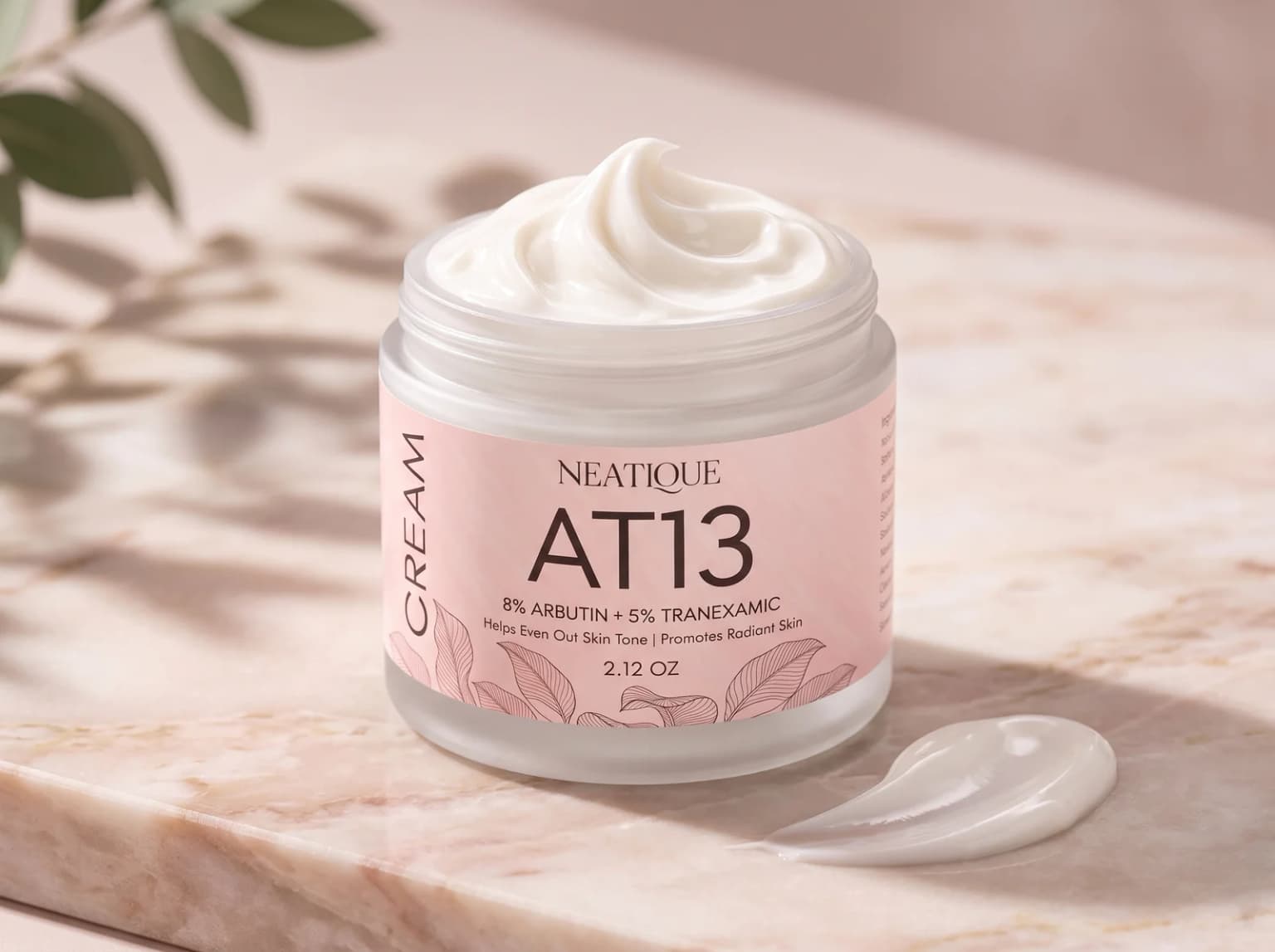 Neatique AT13 arbutin and tranexamic cream arranged with a smooth cream texture on blush stone.