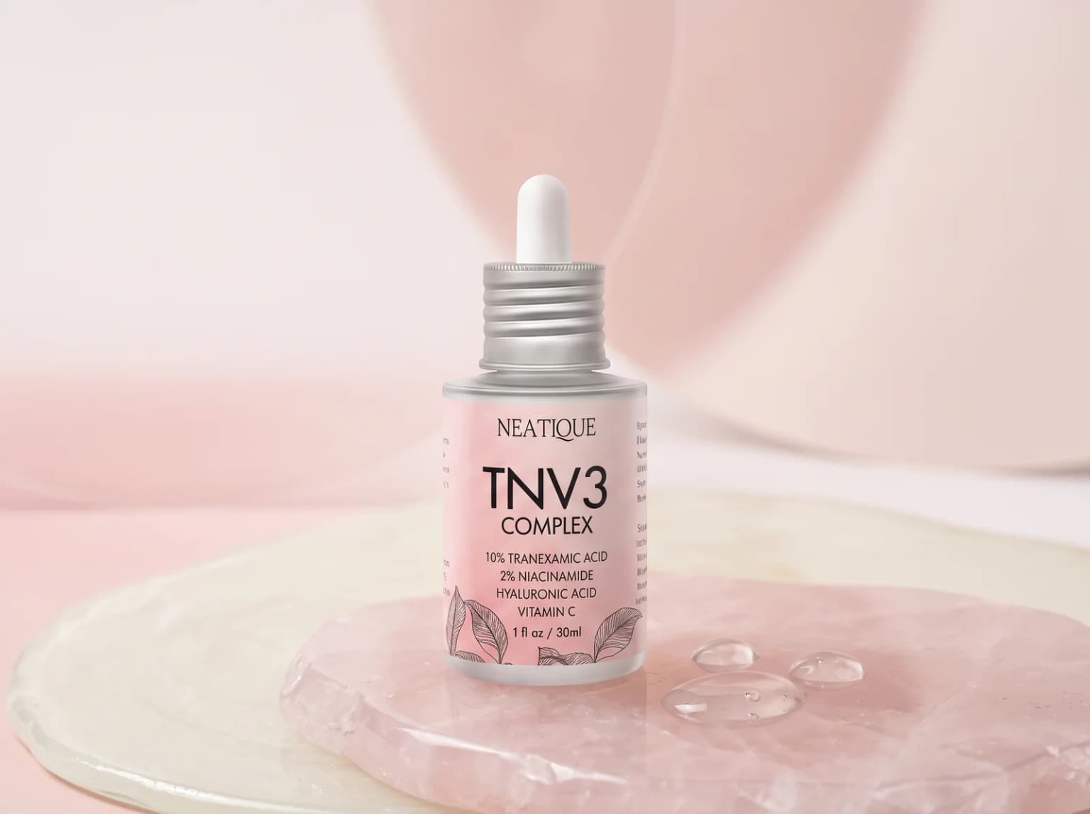Neatique TNV3 tranexamic acid serum with clear serum droplets on pale rose glass.